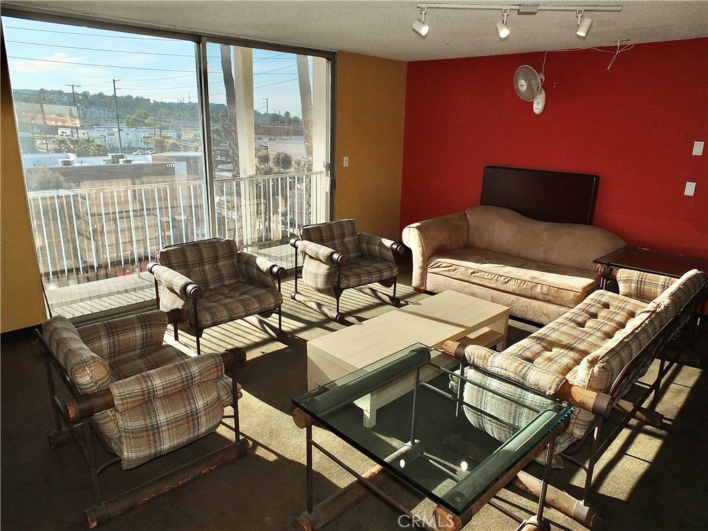 1770 Ximeno Avenue, Unit 314 Long Beach, CA 90815 - Photo 27 of 37 a living room with furniture and a floor to ceiling window