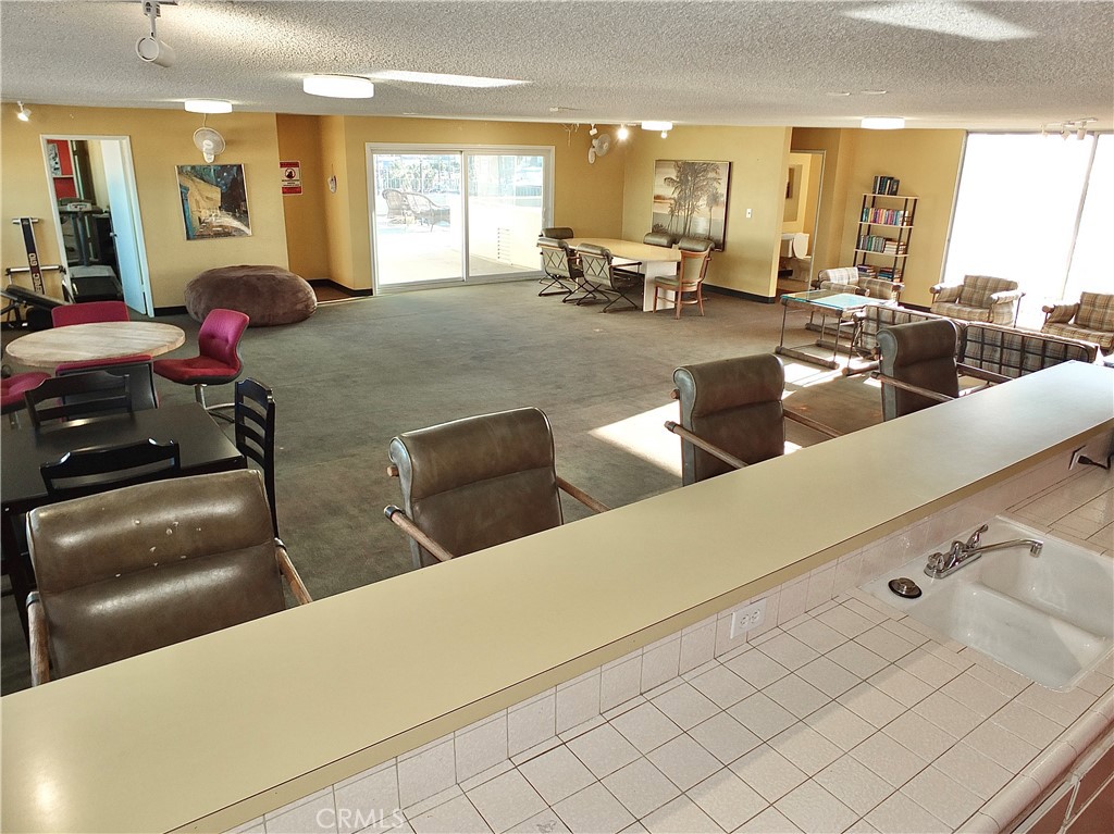 1770 Ximeno Avenue, Unit 314 Long Beach, CA 90815 - Photo 31 of 37 a living room with couches and kitchen view with wooden floor