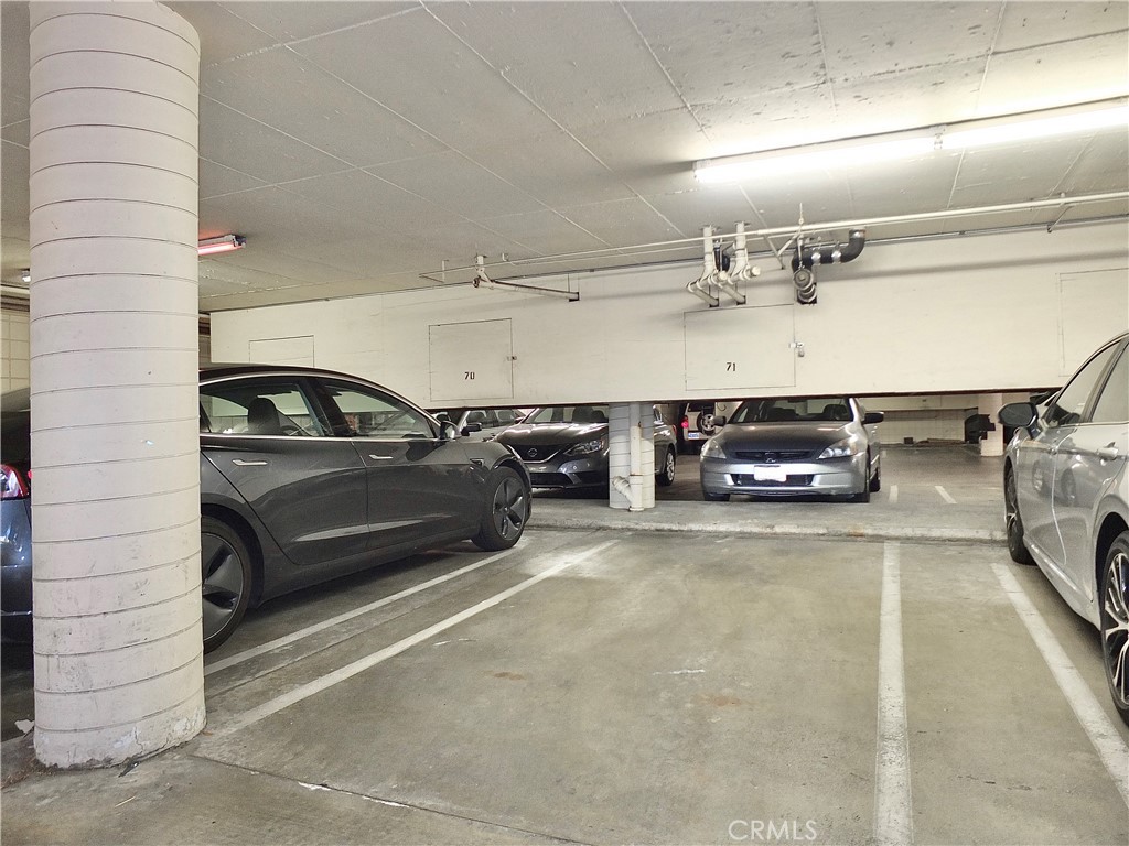 1770 Ximeno Avenue, Unit 314 Long Beach, CA 90815 - Photo 33 of 37 a view of parking garage with cars