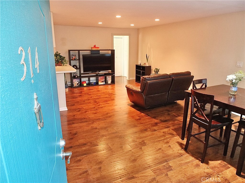 1770 Ximeno Avenue, Unit 314 Long Beach, CA 90815 - Photo 4 of 37 a living room with furniture and a flat screen tv