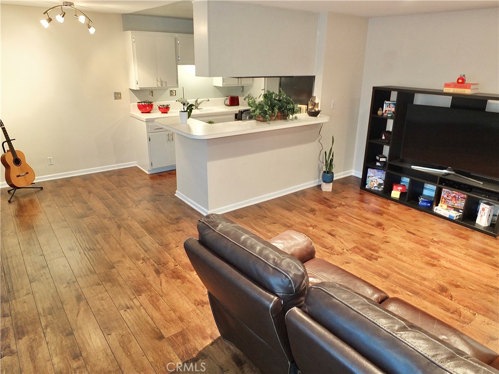 1770 Ximeno Avenue, Unit 314 Long Beach, CA 90815 - Photo 5 of 37 a room with kitchen island and flat screen tv