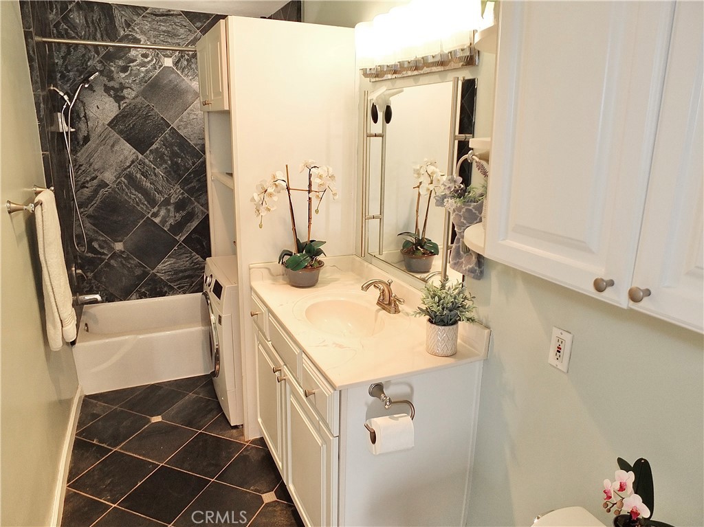 1770 Ximeno Avenue, Unit 314 Long Beach, CA 90815 - Photo 7 of 37 a bathroom with a sink and a mirror