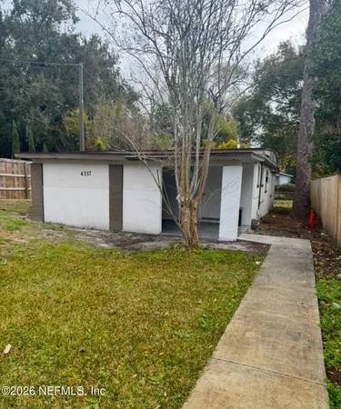 a front view of house with yard and trees