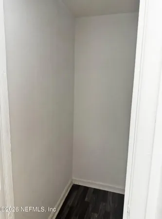 a view of a room with wooden floor