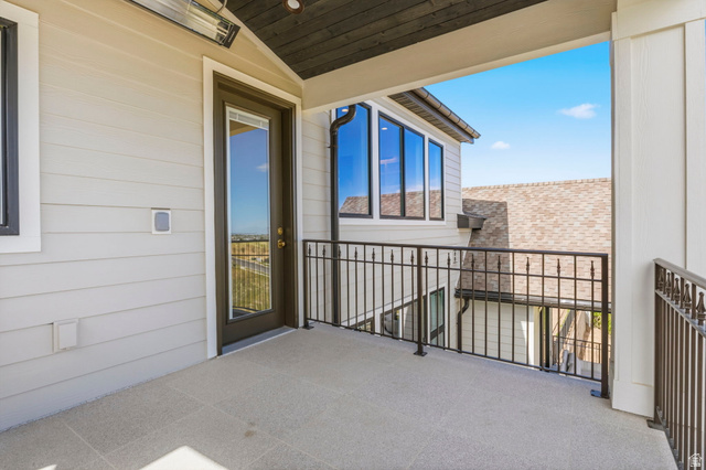 115 East Hidden Ridge Lane, Unit 42 Mapleton, UT 84664 - Photo 50 of 103 Outdoor balcony with light-toned flooring, black wrought iron railing, and a full-light exterior door