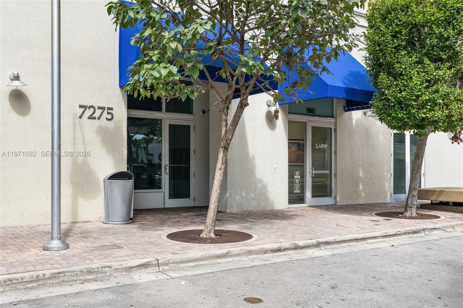 7275 Southwest 90th Way, Unit 404 Miami, FL 33156 - Photo 2 of 35 a front view of a house with garden and plants