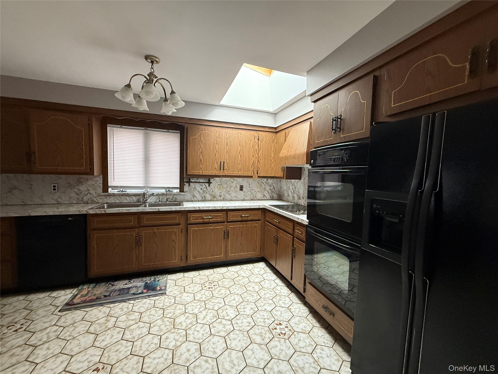 1926 Midlane Road Syosset, NY 11791 - Photo 16 of 21 a kitchen with a sink a stove cabinets and stainless steel appliances