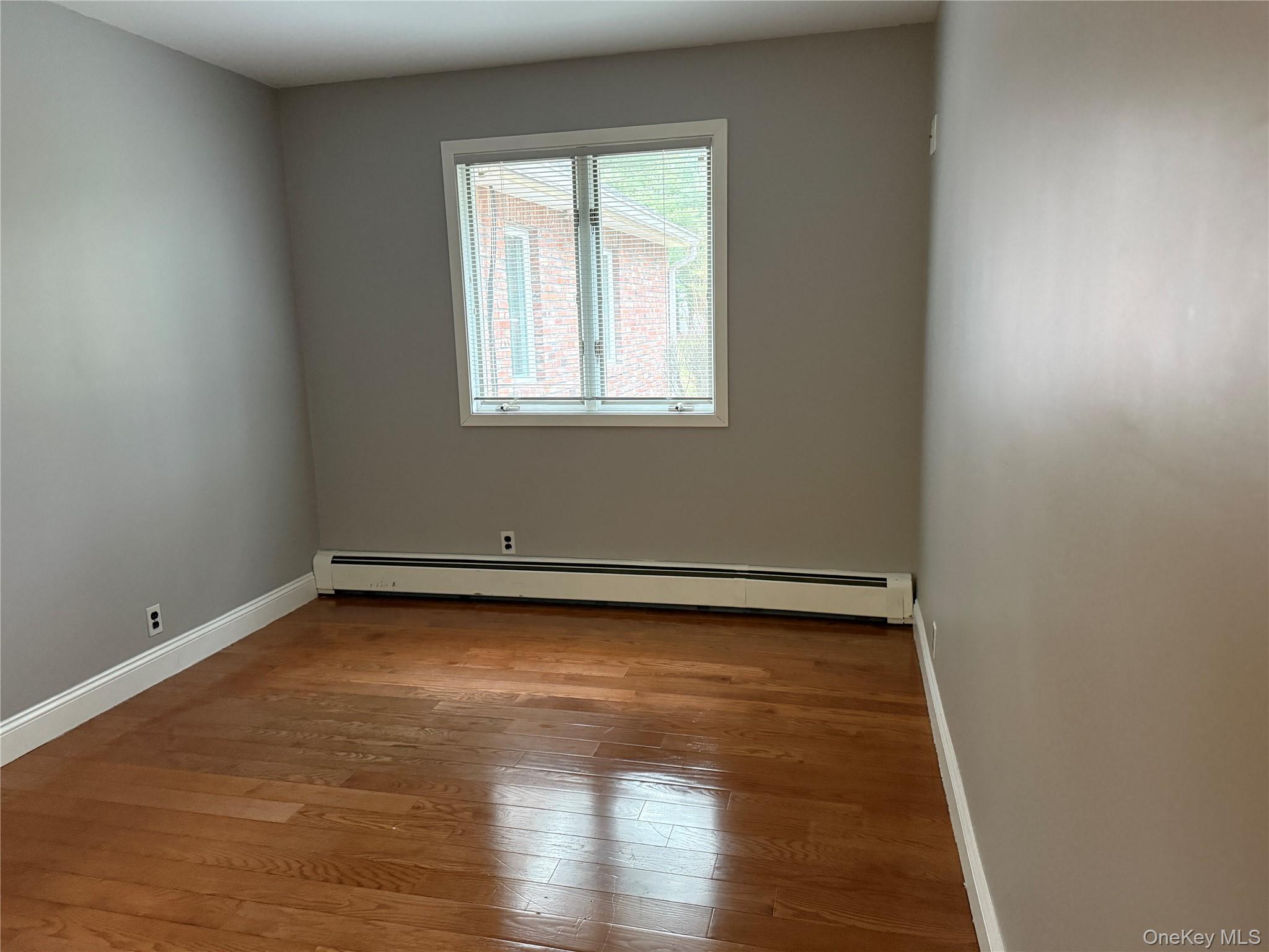 1926 Midlane Road Syosset, NY 11791 - Photo 7 of 21 a view of a room with wooden floor and window
