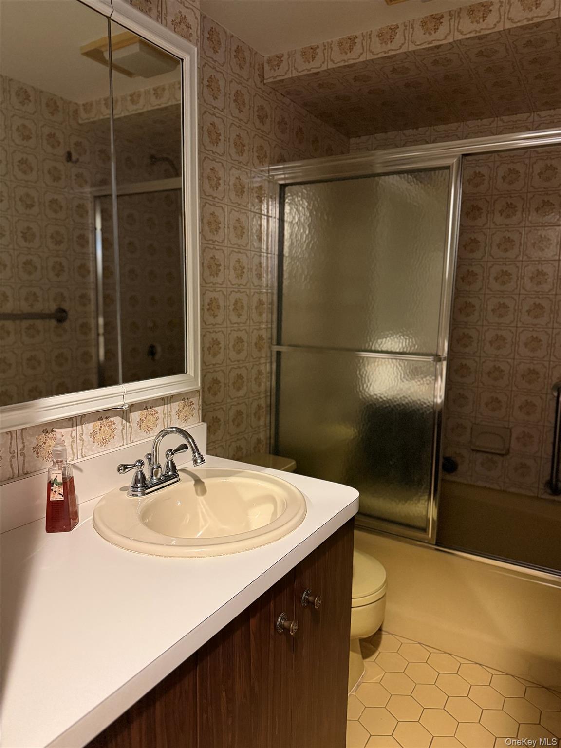 1926 Midlane Road Syosset, NY 11791 - Photo 8 of 21 a bathroom with a sink and a mirror