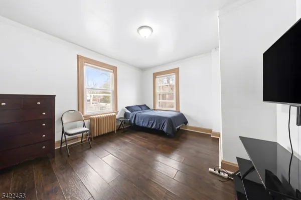 a bedroom with a bed and a chair