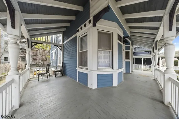 a view of a porch with furniture and a gate
