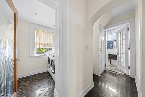 a view of a hallway to rooms