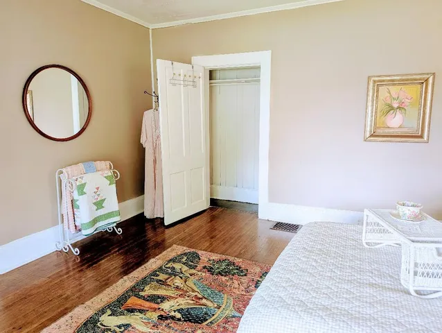 a view of a room with wooden floor and bathroom