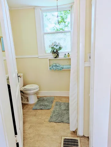 a bathroom with a toilet and a shower