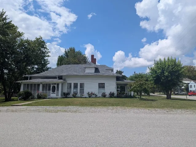 a front view of house with yard and green space