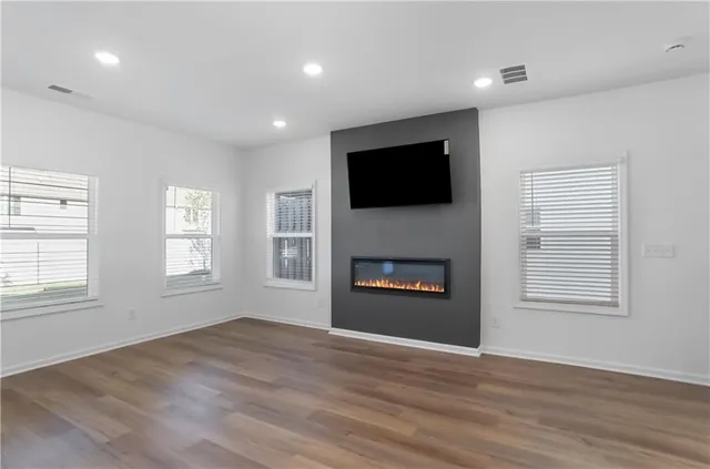 a view of an empty room with a walk in closet and closet