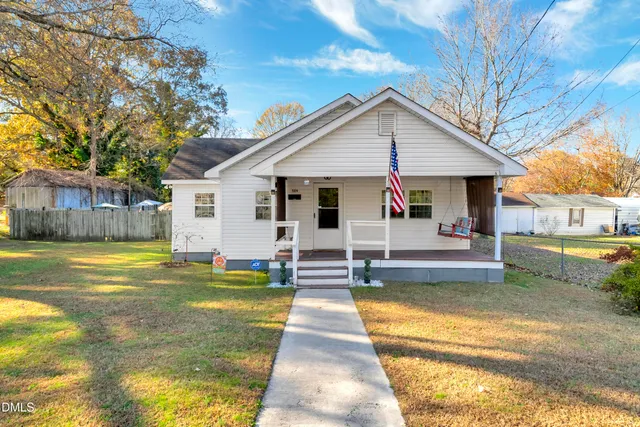 a view of a house with swimming pool and a garden