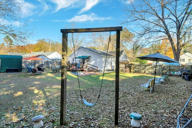 a view of a patio with table and chairs under an umbrella
