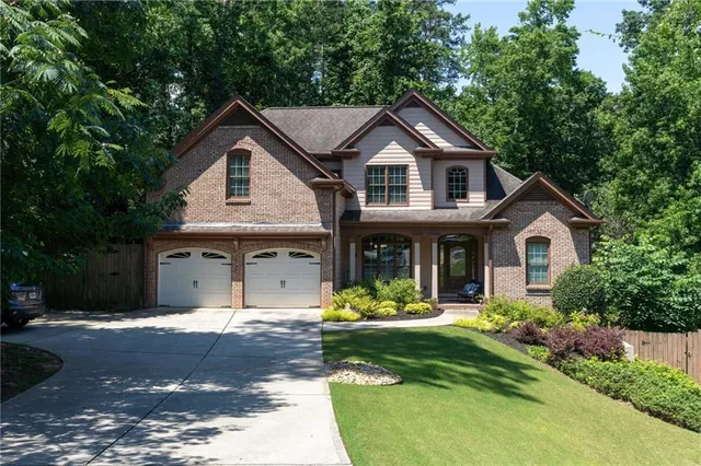 a front view of a house with a yard garage and outdoor seating