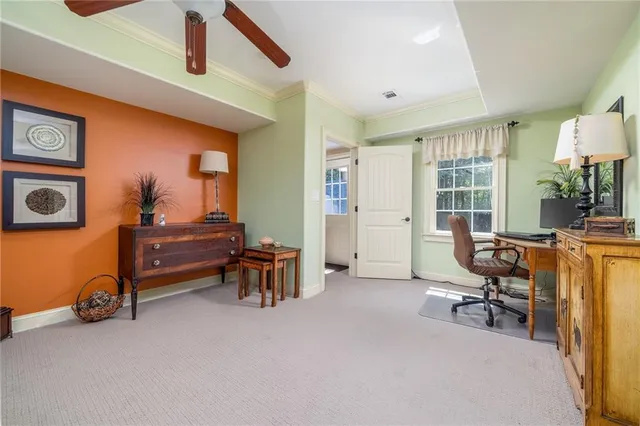 a view of a livingroom with workspace and a window