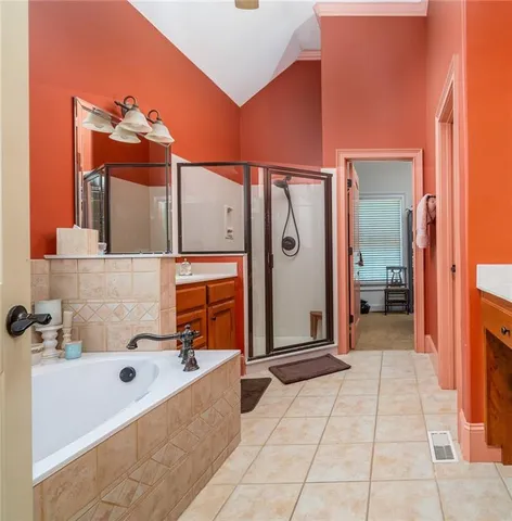 a bathroom with a tub sink and mirror