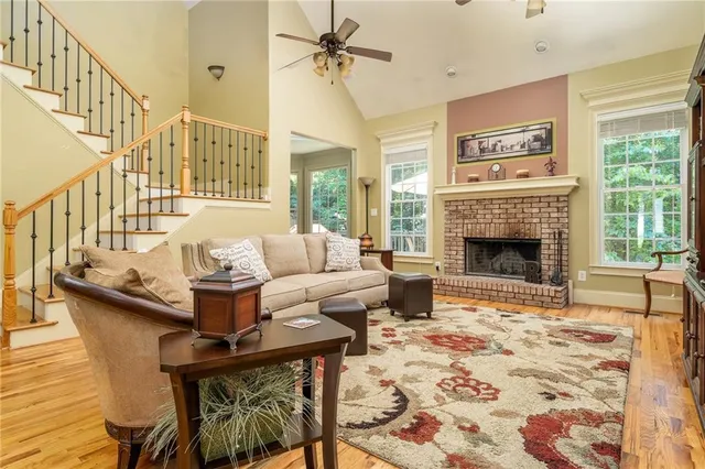 a living room with furniture fireplace and a window