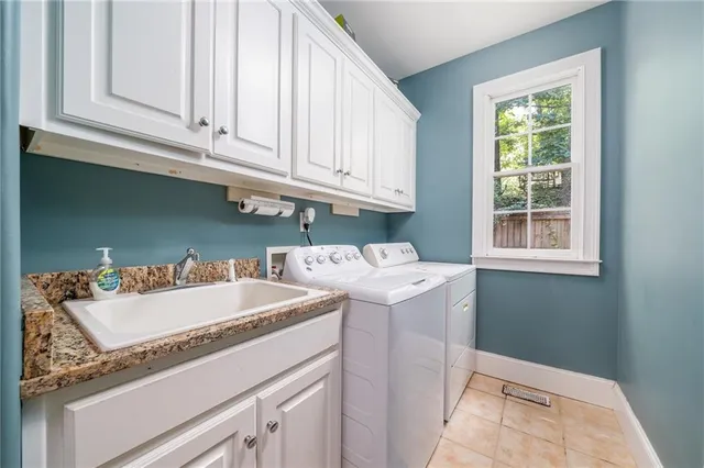 a utility room with a sink washer and dryer
