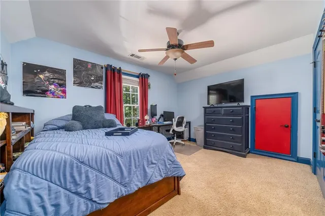 a bed room with a bed and a television