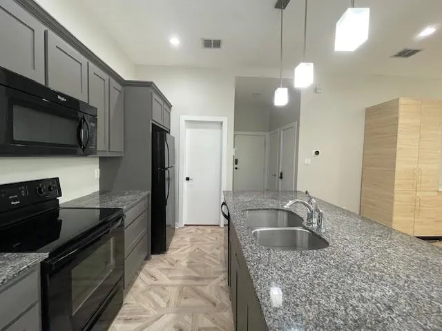 a kitchen with a sink stove and refrigerator