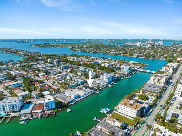 an aerial view of residential houses with outdoor space and river