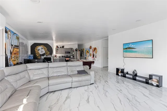 a living room with furniture a couch and a dresser