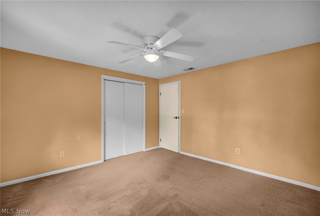 6845 Liberty Road Solon, OH 44139 - Photo 31 of 47 Room featuring neutral-toned carpet flooring, a ceiling fan with integrated lighting, and a white trim baseboard