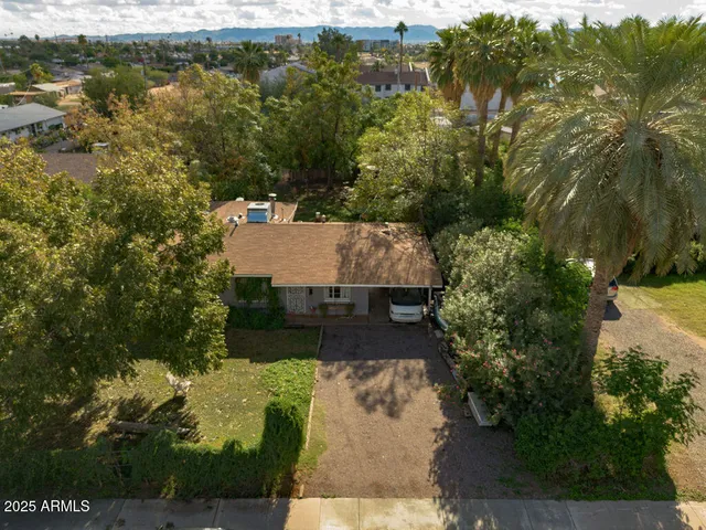 an aerial view of a house with a yard basket ball court and outdoor seating