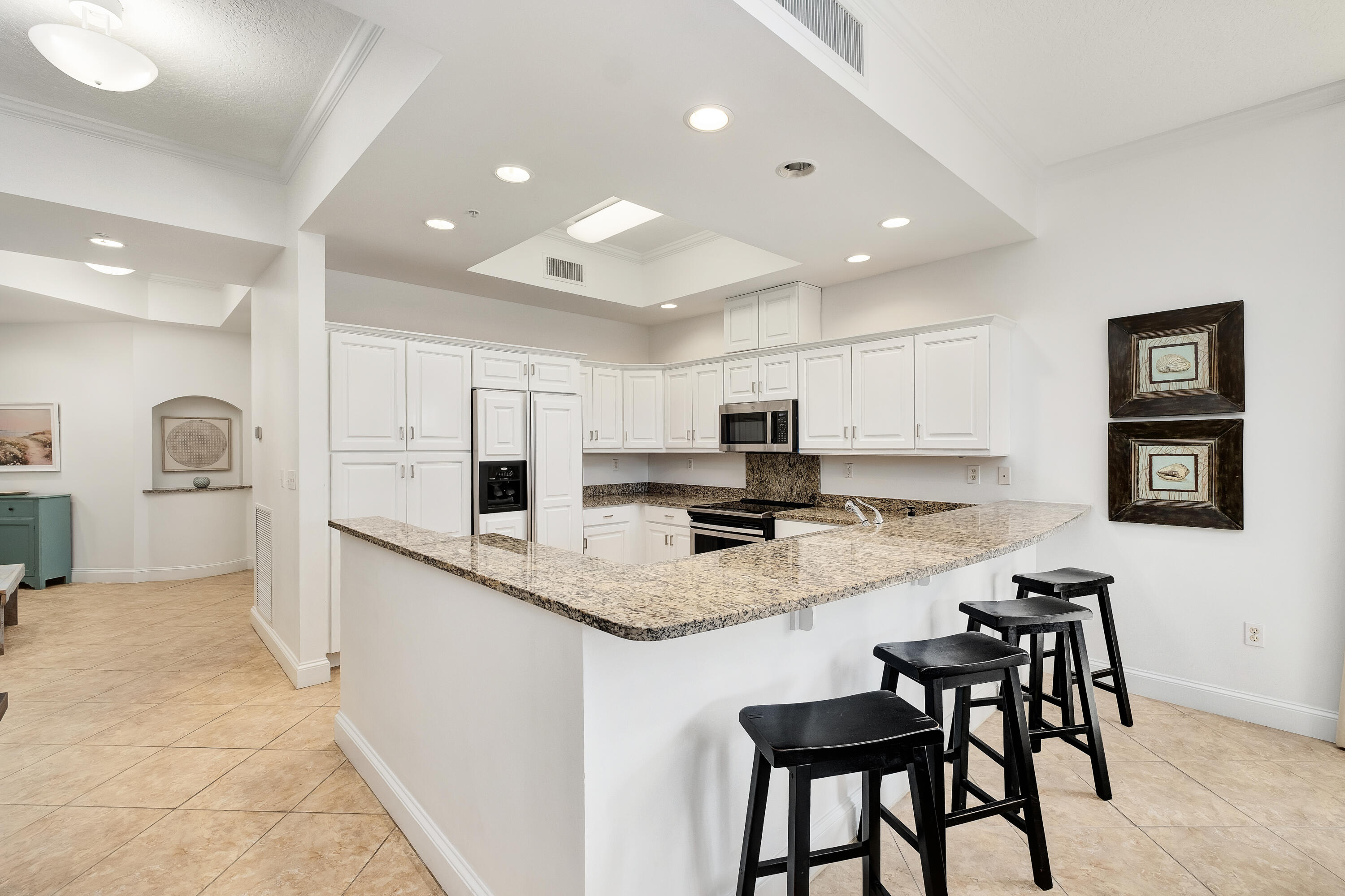 9961 East County Highway 30A, Unit 202 Inlet Beach, FL 32461 - Photo 12 of 44 a kitchen with stainless steel appliances granite countertop a stove top oven a sink a refrigerator and a refrigerator