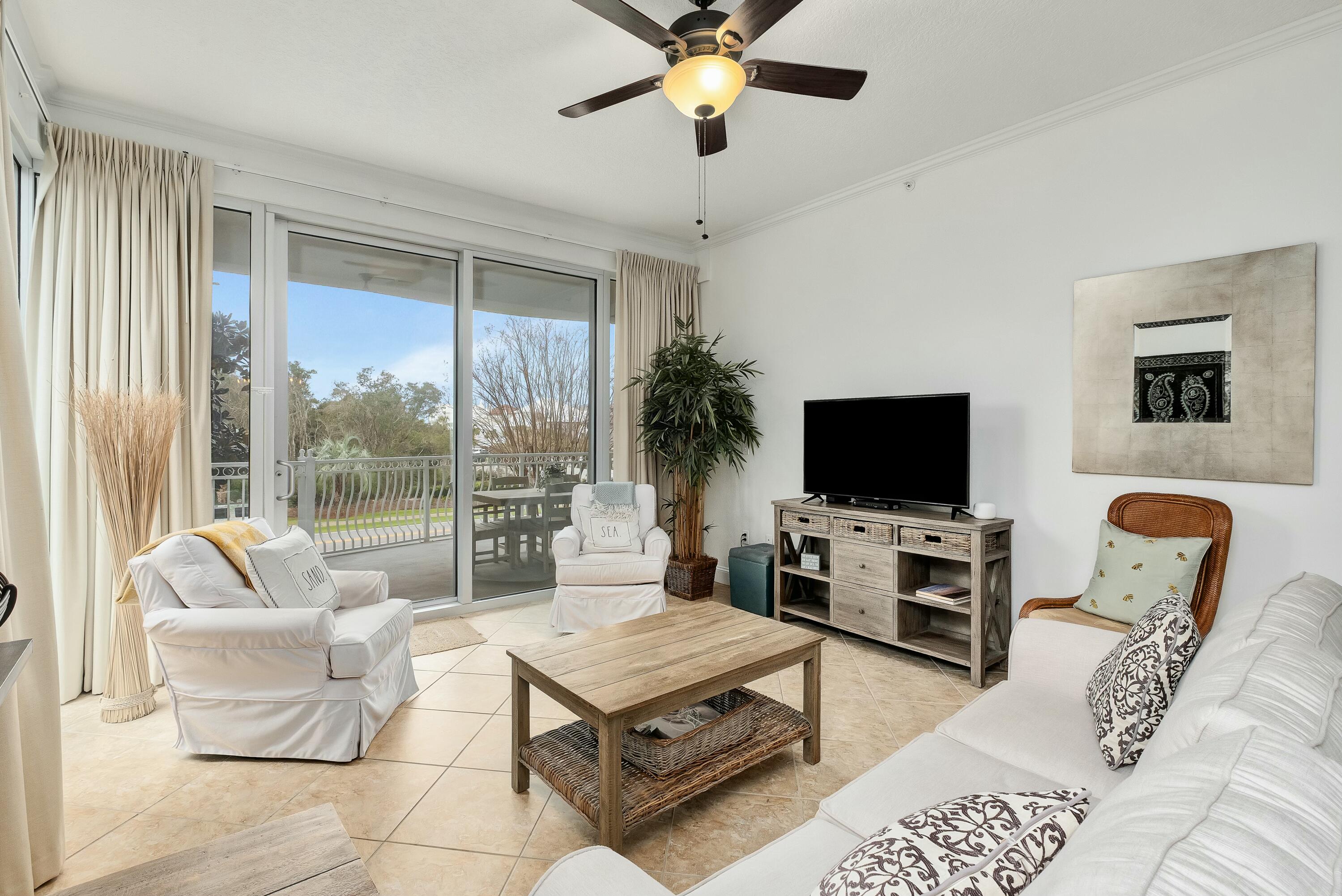 9961 East County Highway 30A, Unit 202 Inlet Beach, FL 32461 - Photo 2 of 44 a living room with furniture a flat screen tv and a large window