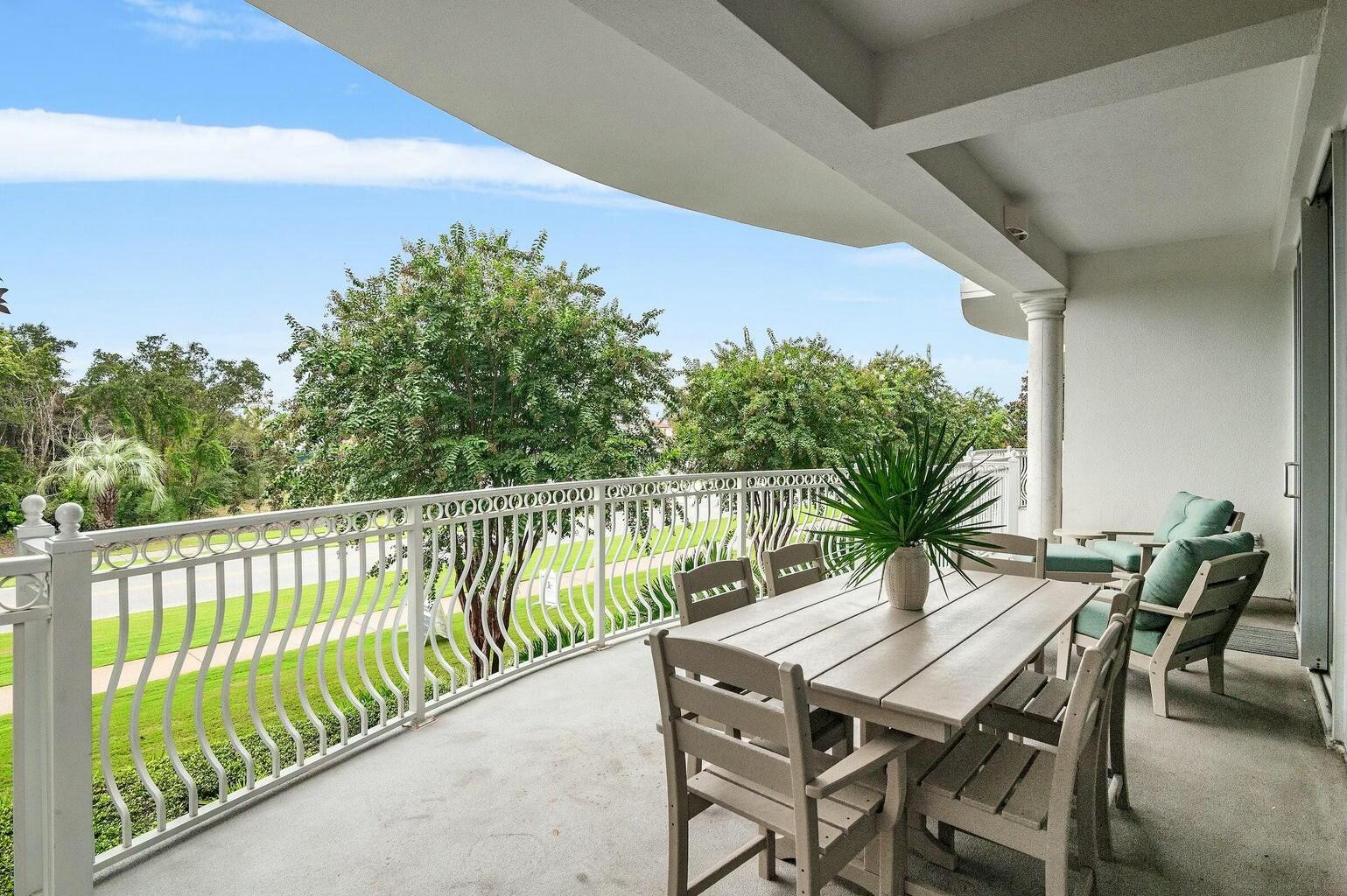 9961 East County Highway 30A, Unit 202 Inlet Beach, FL 32461 - Photo 5 of 44 a balcony with wooden floor table and chairs
