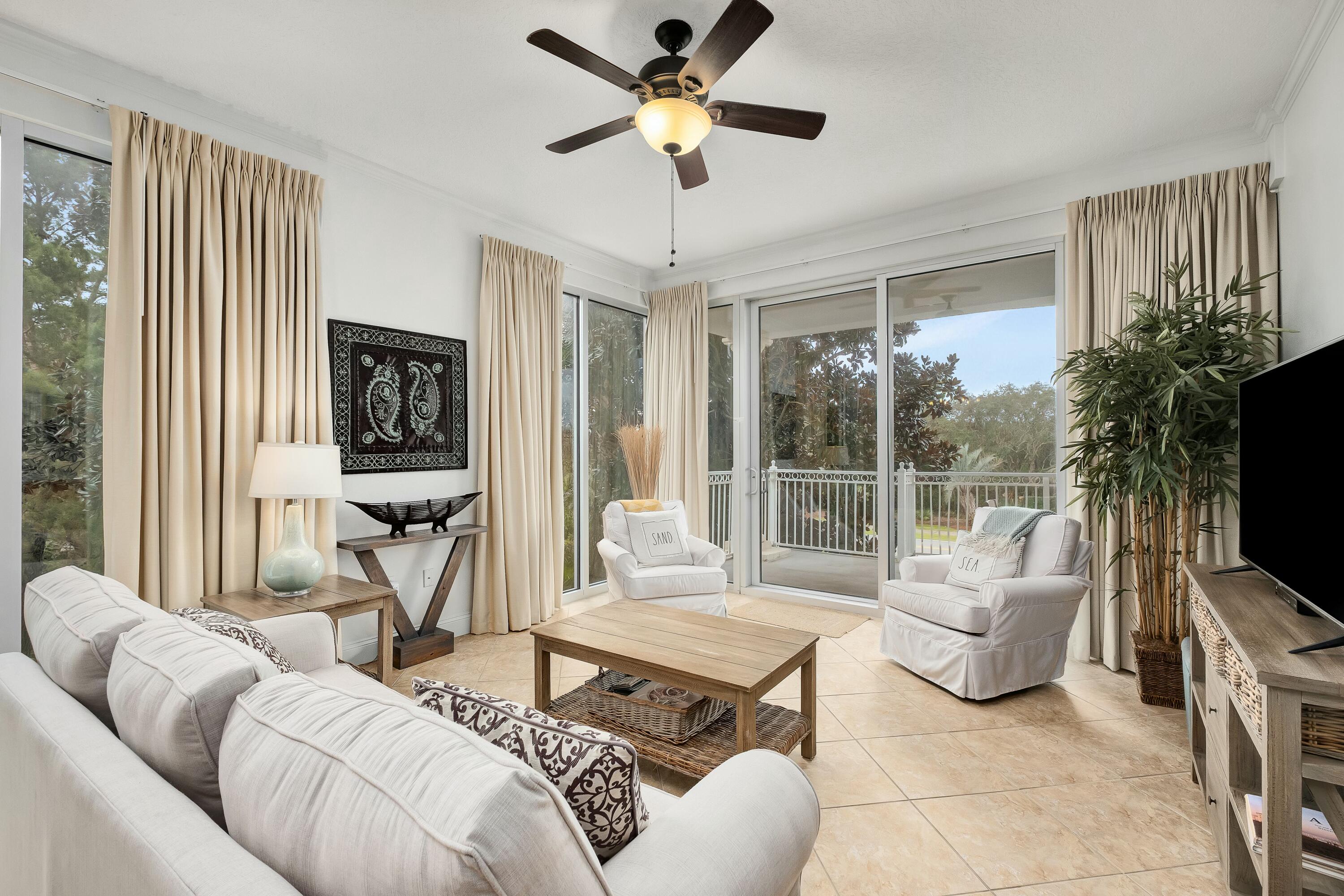 9961 East County Highway 30A, Unit 202 Inlet Beach, FL 32461 - Photo 7 of 44 a living room with furniture a flat screen tv and a large window