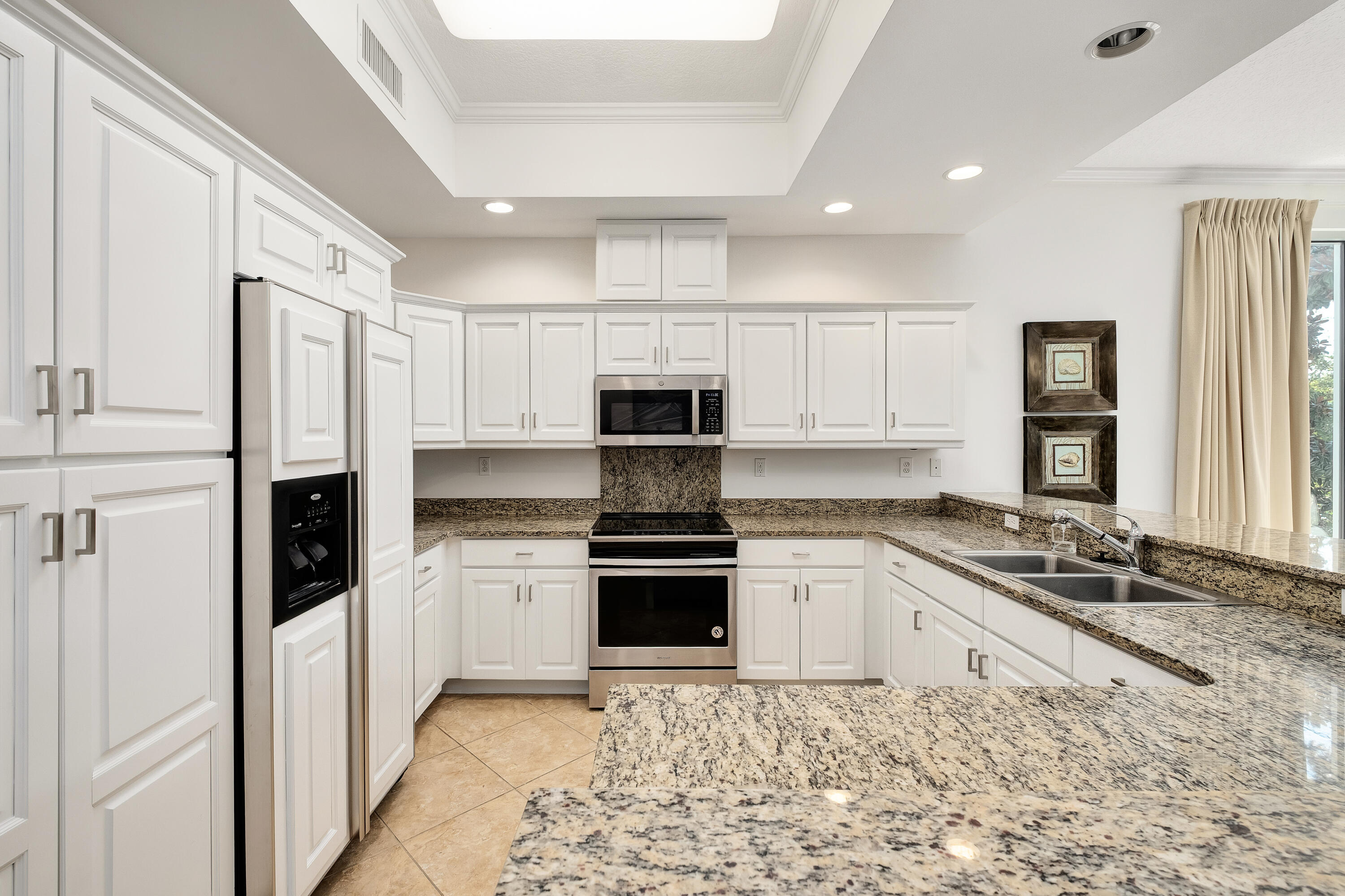 9961 East County Highway 30A, Unit 202 Inlet Beach, FL 32461 - Photo 8 of 44 a kitchen with granite countertop white cabinets and stainless steel appliances