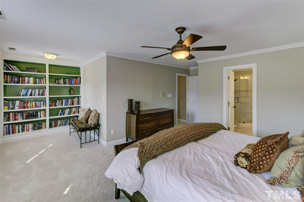 6300 Battleview Drive Raleigh, NC 27613 - Photo 18 of 25 a bedroom with a bed and a chandelier
