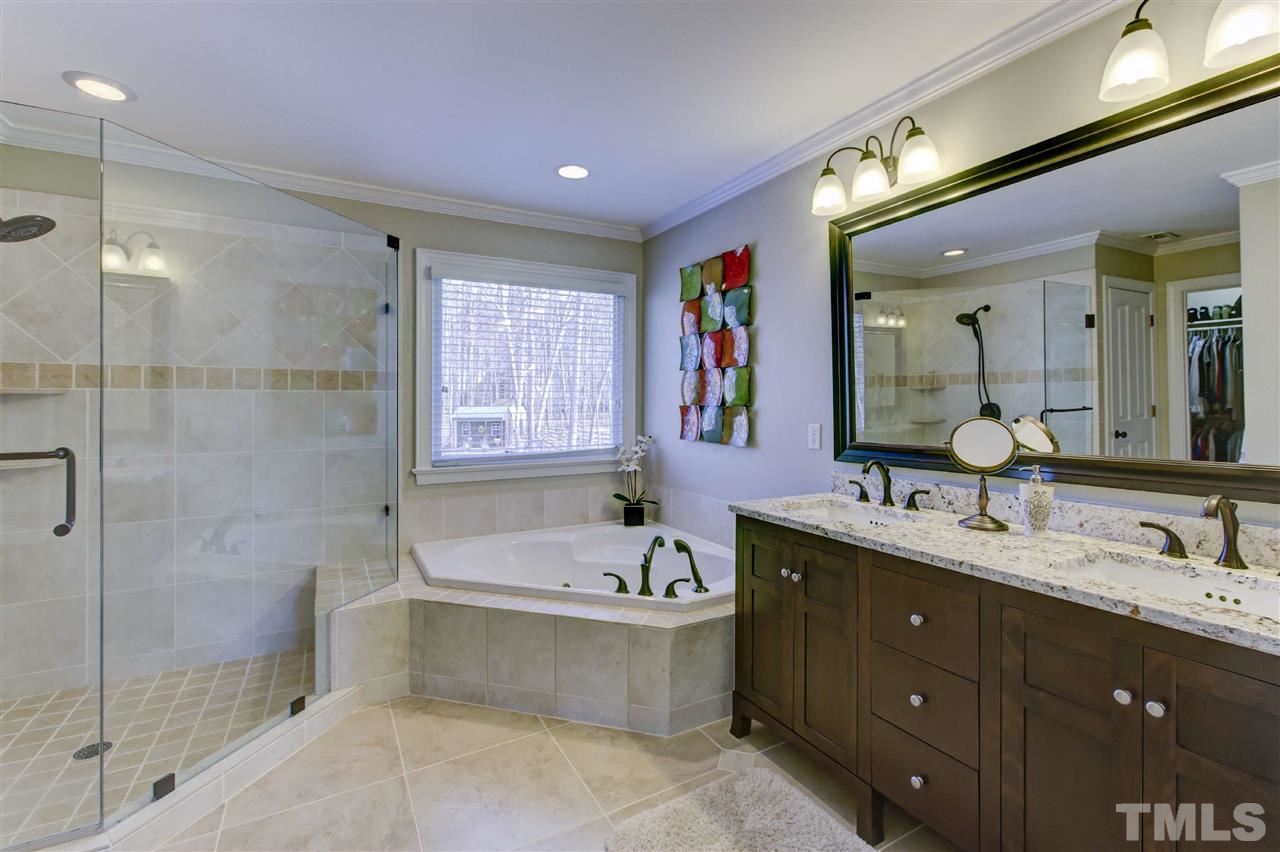 6300 Battleview Drive Raleigh, NC 27613 - Photo 20 of 25 a bathroom with a tub sink double vanity granite and shower