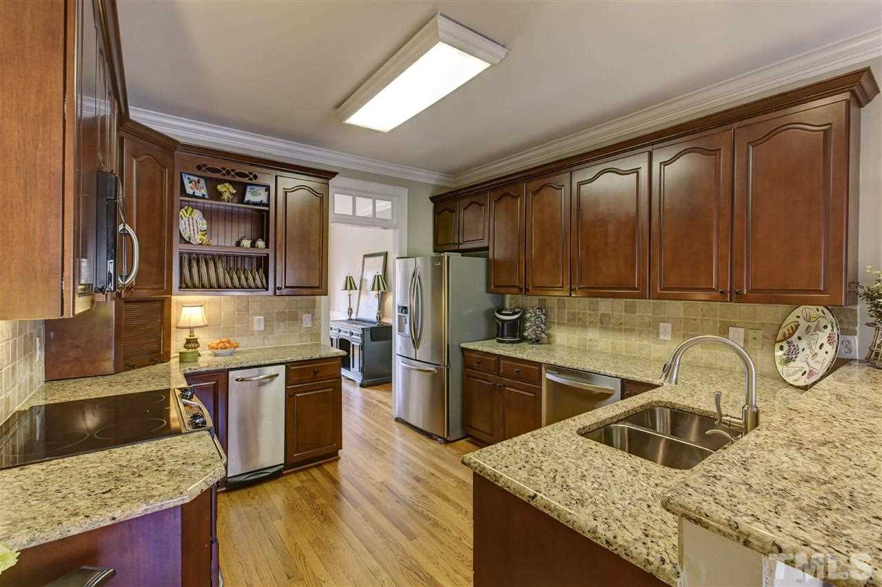 6300 Battleview Drive Raleigh, NC 27613 - Photo 7 of 25 a kitchen with stainless steel appliances granite countertop a sink stove and refrigerator