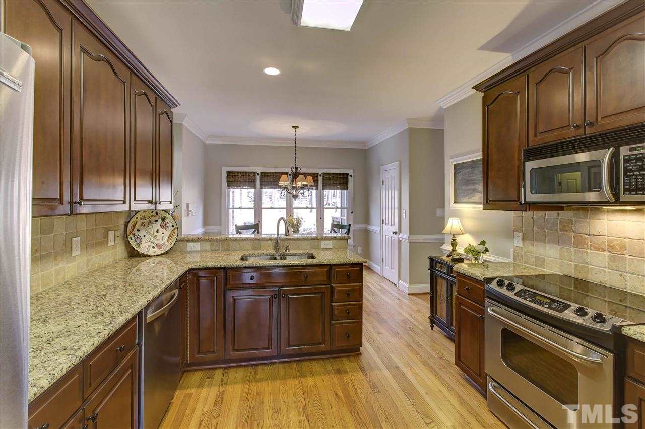 6300 Battleview Drive Raleigh, NC 27613 - Photo 8 of 25 a kitchen with granite countertop stainless steel appliances and wooden cabinets