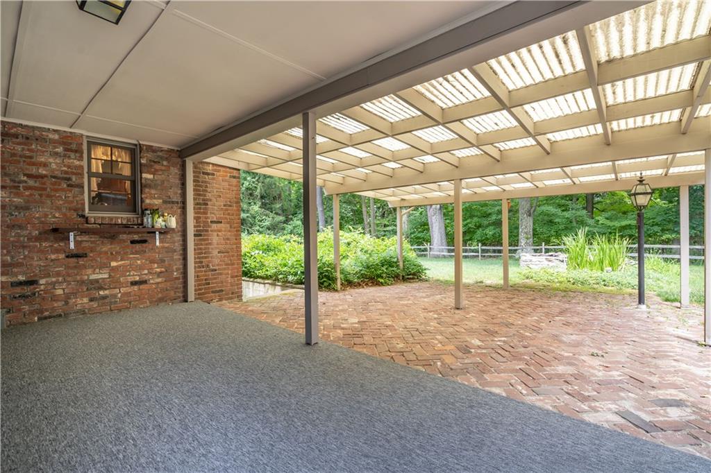 121 Sylvania Drive Pittsburgh, PA 15236 - Photo 20 of 25 OUT SIDE COVERED PATIO AREA THAT LEADS TO THE FENCED IN AREA OF THE BACKYARD. THERE IS ALSO A POND WITH FISH IN THE YARD.