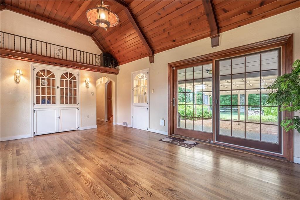121 Sylvania Drive Pittsburgh, PA 15236 - Photo 6 of 25 ANOTHER VIEW OF THE LIVING ROOM WITH BUILT IN CABINETS AND SLIDING GLASS DOORS LEADING TO THE OUTSIDE PATIO.