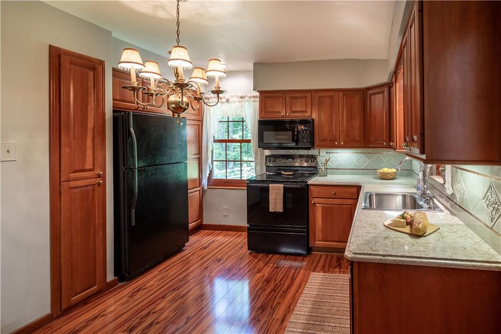121 Sylvania Drive Pittsburgh, PA 15236 - Photo 8 of 25 BEAUTIFUL KITCHEN WITH CHERRY CABINETS, QUARTZ COUNTER TOPS AND UNDER CABINET LIGHTING.