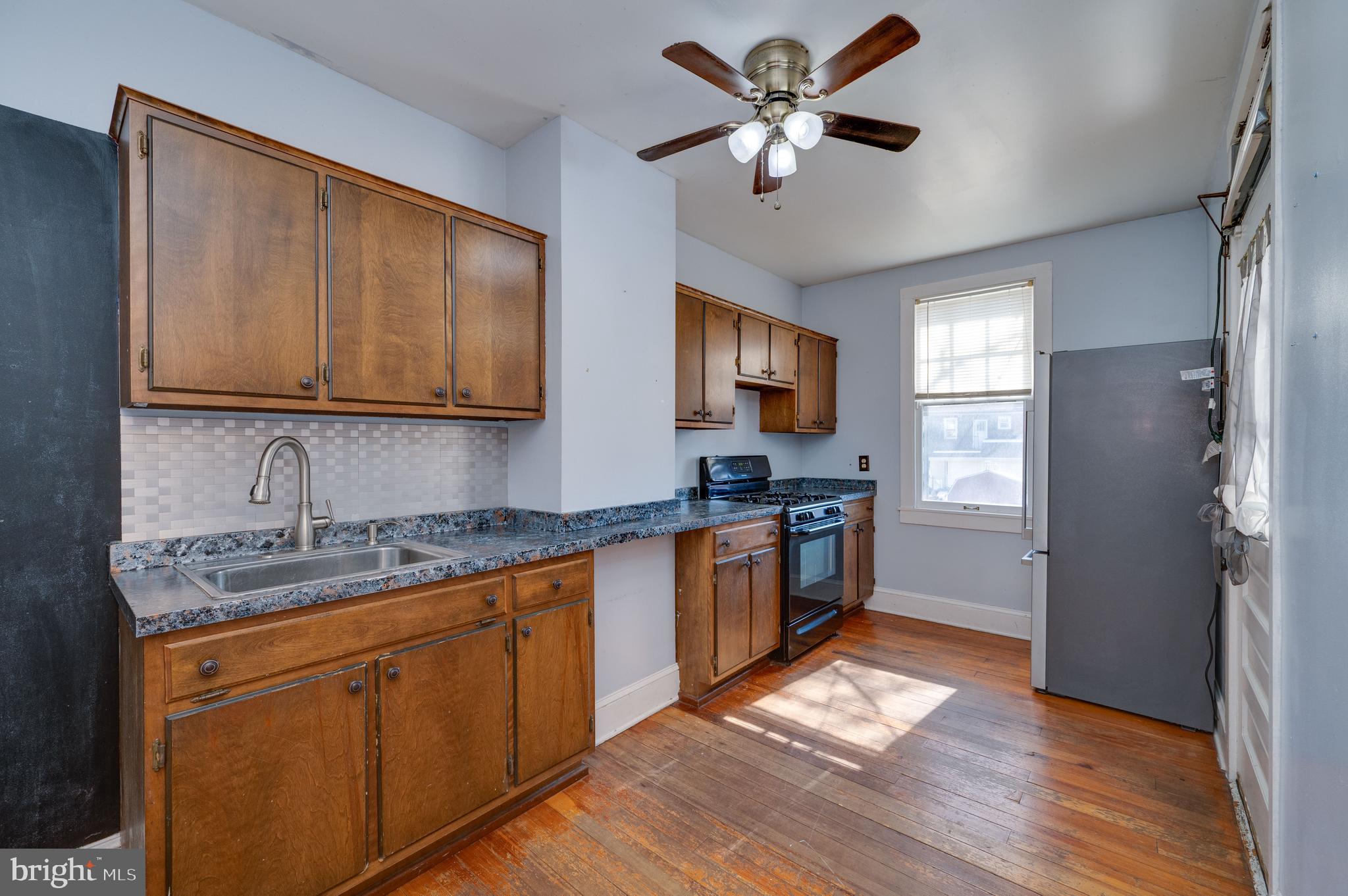 7 Marshall Avenue Reading, PA 19606 - Photo 13 of 36 a kitchen with stainless steel appliances granite countertop a refrigerator a sink dishwasher a stove with wooden cabinets and floor