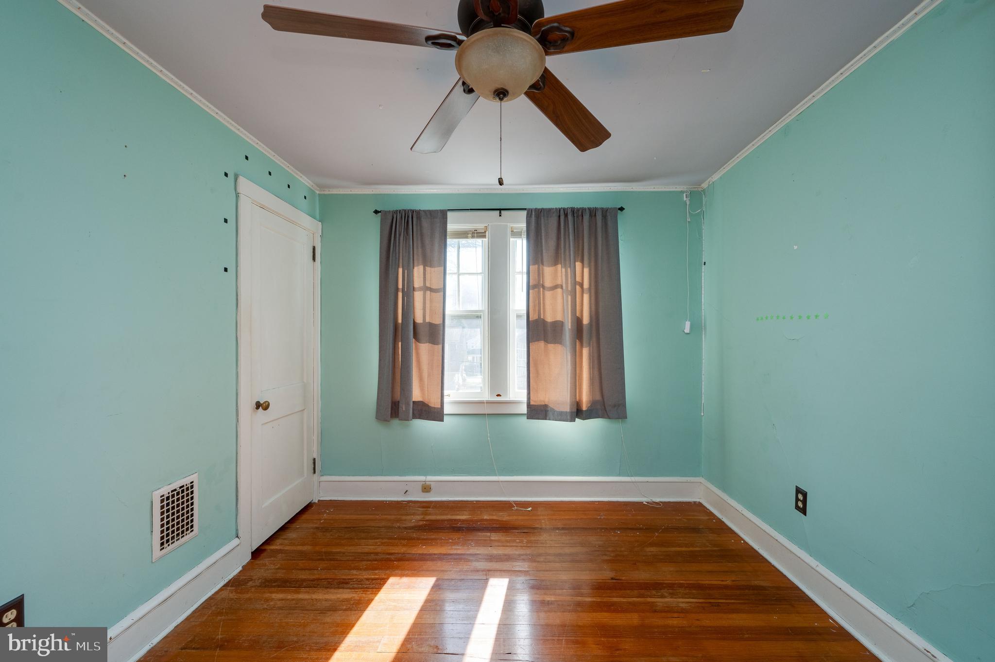 7 Marshall Avenue Reading, PA 19606 - Photo 22 of 36 a view of an empty room with window and wooden floor