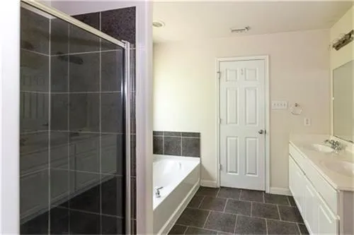 a bathroom with a tub and shower