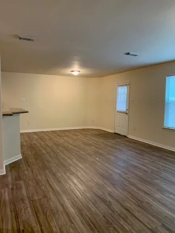 a view of a room with wooden floor