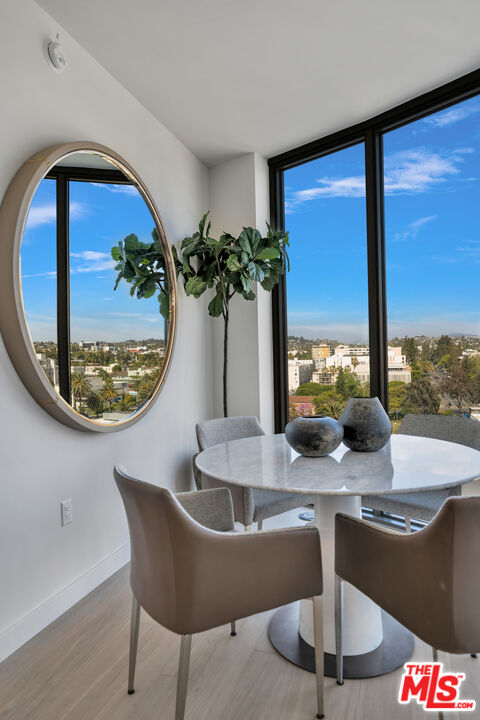 2801 Sunset Place, Unit PH02 Los Angeles, CA 90005 - Photo 16 of 16 a dining room with table and chairs